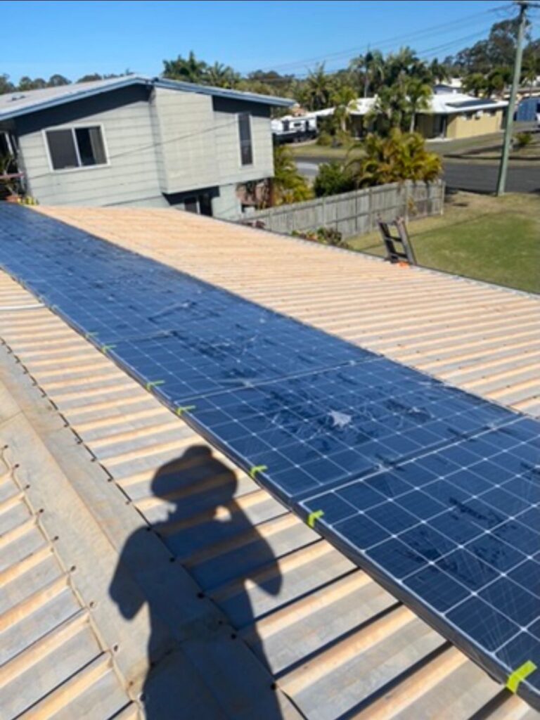 Metal oof with solar panels before cleaning and painting